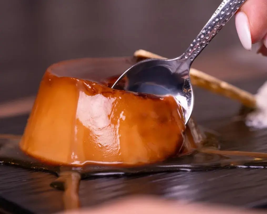 Soft Caramel Pudding Being Eaten