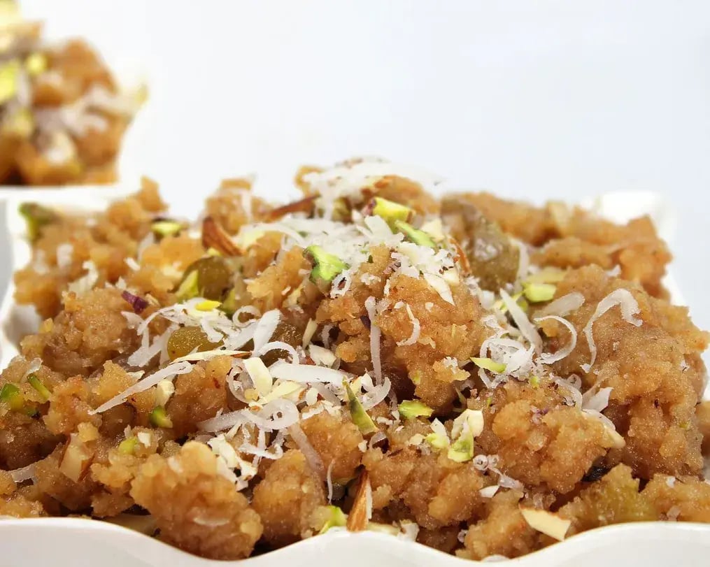 Cardamom Bournville Lapsi With Wheat And Dry Fruits On A Plate