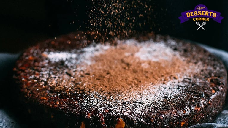 Feature Image - Cocoa powder dusting on a chocolate plum cake