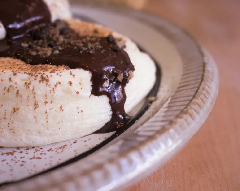 Frozen Lemon Souffle with Pistachios and Oreo Crumble: A Refreshing Dessert - Freshly prepared Lemon Souffle with Chocolate Garnish