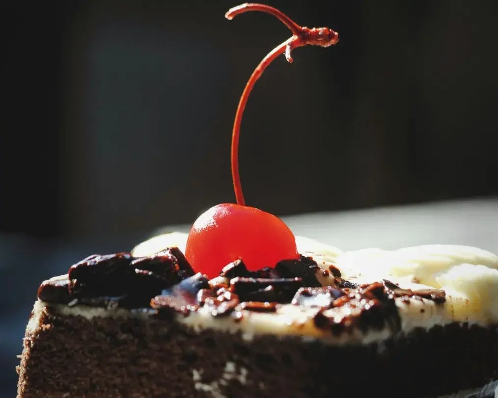 Close View of a Slice of Black Forest Dump Cake with Oreo Crumbs