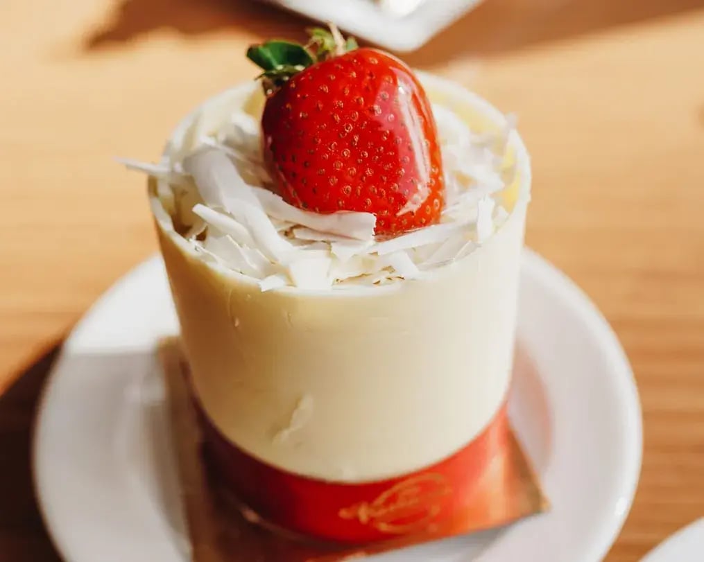 chikoo mousse with walnuts topped with candied strawberry