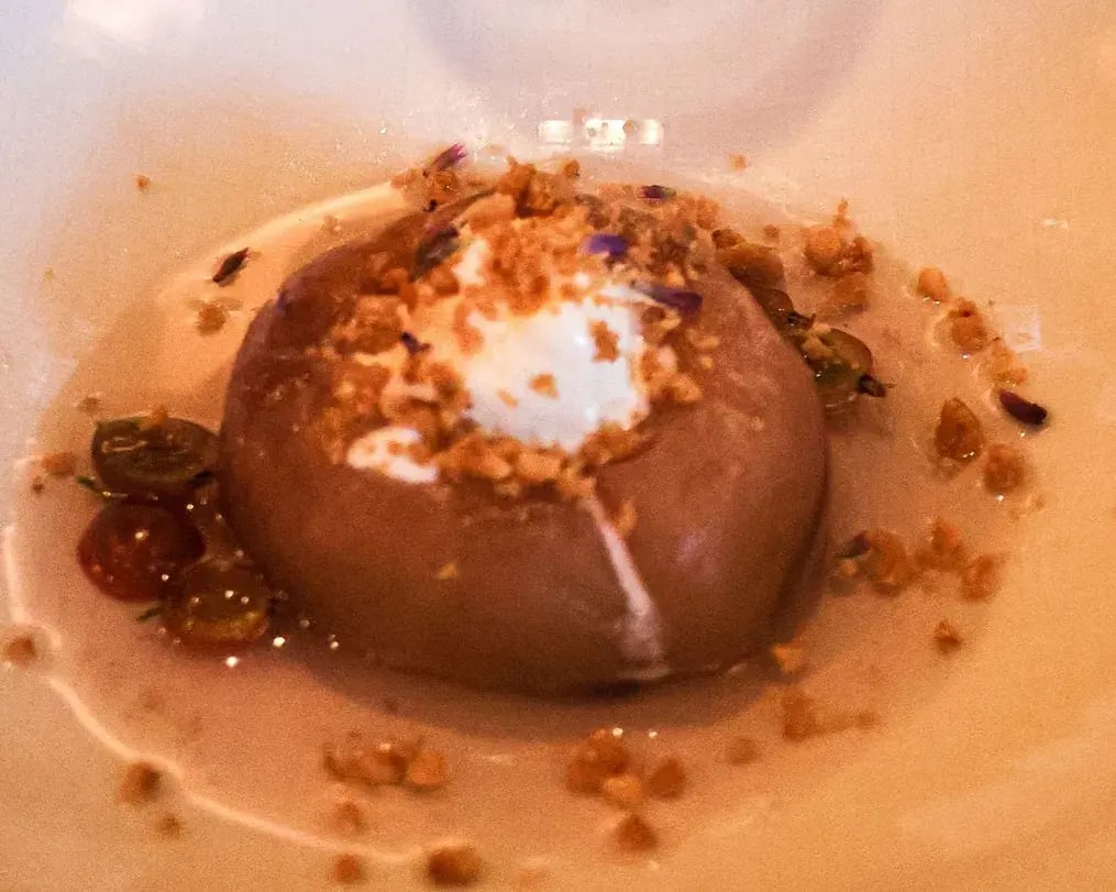 How to Make Elegant Merlot Poached Pears for Wine Day - Garnished poached pear on a plate