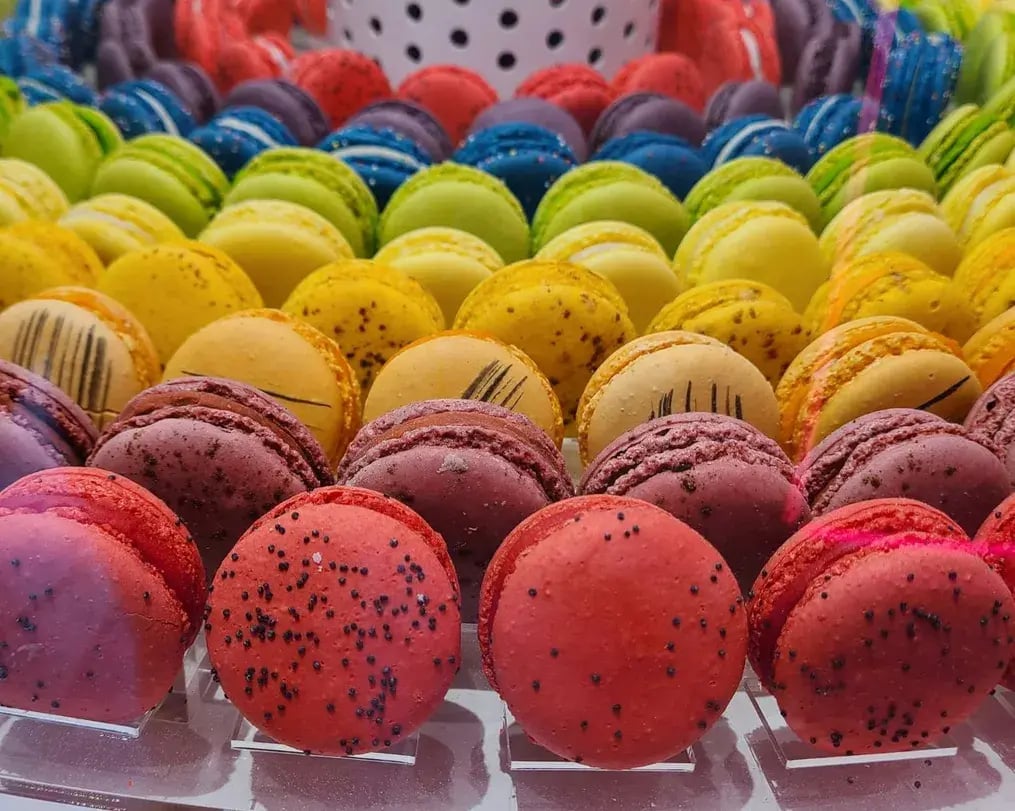 Rainbow Macarons With Ganache Center On Display