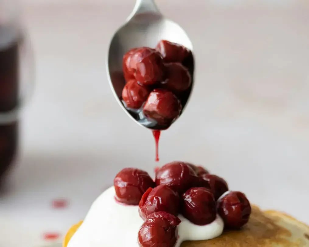 Indulgent Black Forest Dump Cake with Silk Chocolate Swirls: Recipe Guide - Cherry Pie Filling being added on Black Forest Dump Cake