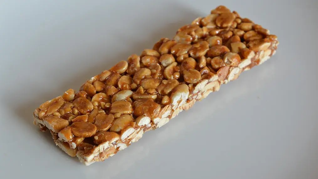 Make delicious flat candies at home that are crunchy treats packed with peanuts - crunchy Handmade Peanut Brittle - 2