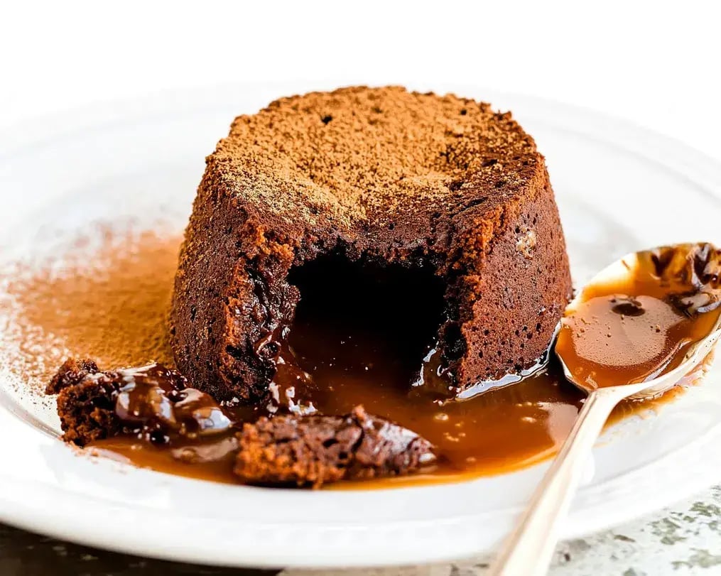 Chocolate lava cake cut with cocoa dusting