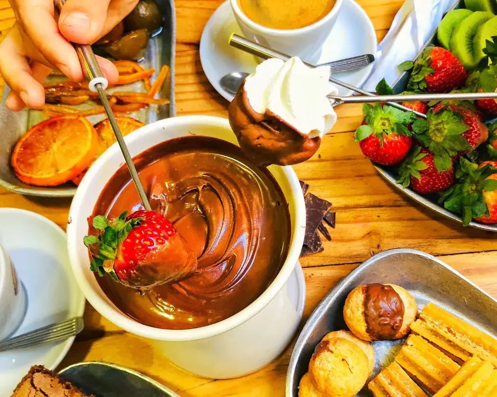 Fruits Being Dipped In Fondue