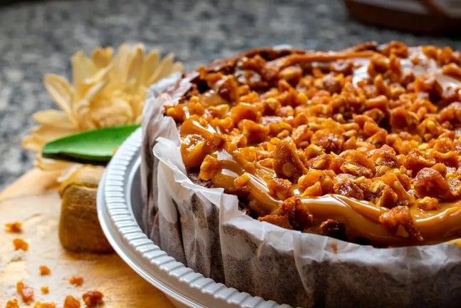 The perfect praline topped caramel frosted cashew nut cake recipe - Feature