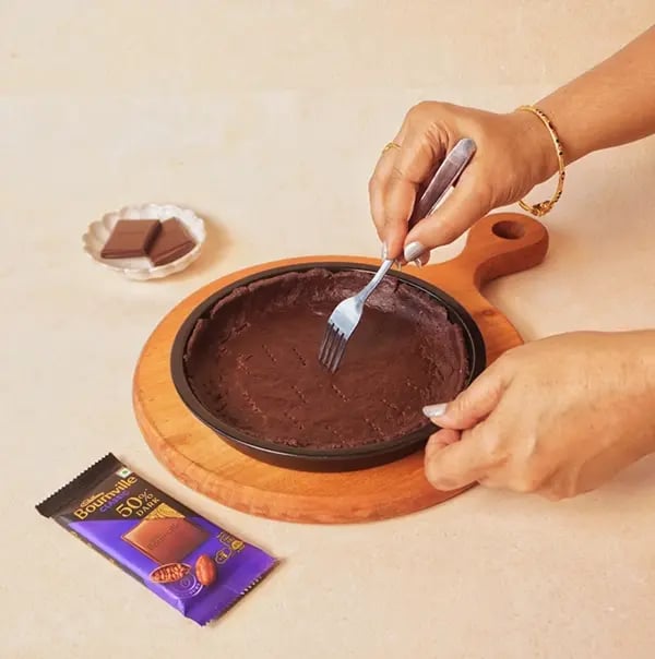 Avocado and Chocolate Bournville Tart with Nuts- Prick the base of the tart shell