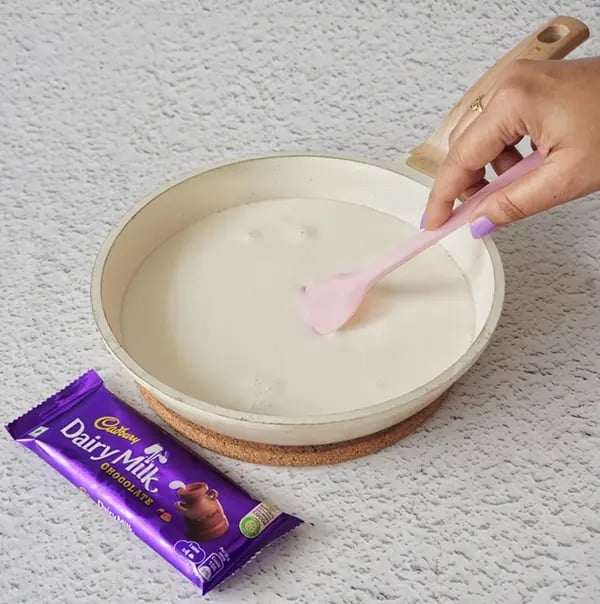 Basundi With Dry Fruits and Cadbury Dairy Milk Chocolate-In a pan bring the milk to a boil