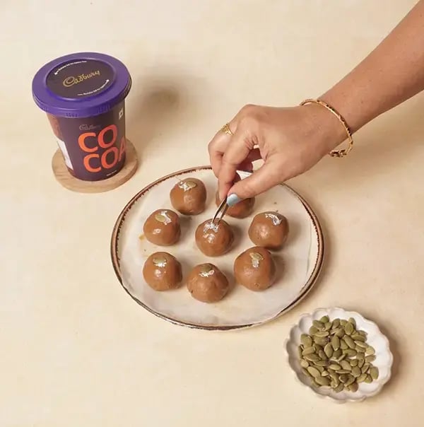 Besan Chocolate Ladoo With Nuts For Raksha Bandhan - Garnish each ladoo with a small piece of edible silver leaf