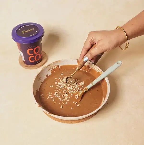 Besan Chocolate Ladoo With Nuts For Raksha Bandhan - Sprinkle cardamom powder