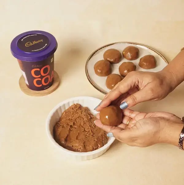 Besan Chocolate Ladoo With Nuts For Raksha Bandhan - Take small portions of the dough and roll them
