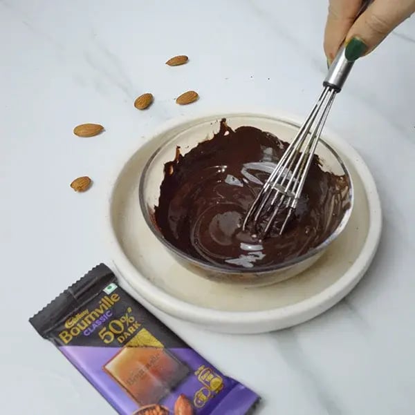 Bournville Almond Chikki Sweet - Mix melted chocolate