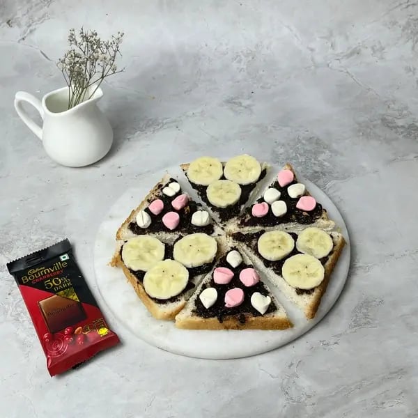 Bournville Banana Bread Pizza Dessert - Melting Chocolate Pieces
