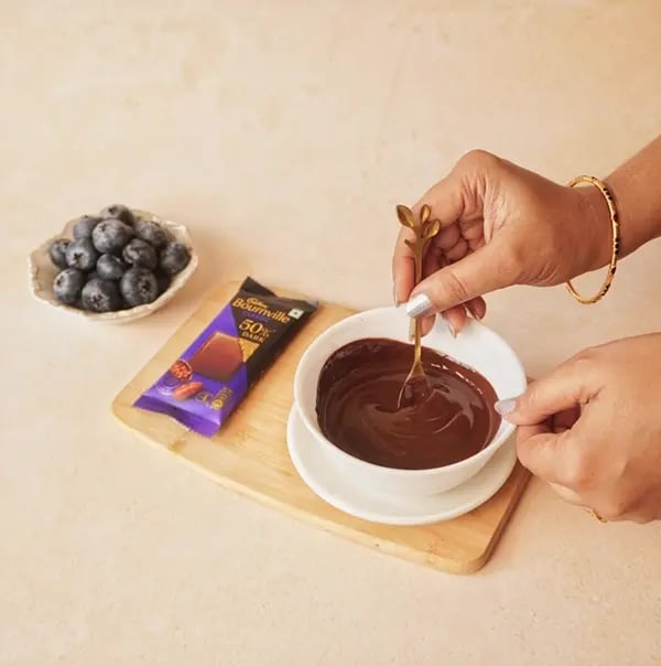 Bournville Blueberry Treats-Dip each blueberry into the melted chocolate