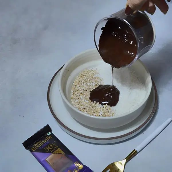 Bournville Caramel Cashew Chocolate Bar - Pour melted chocolate with oats