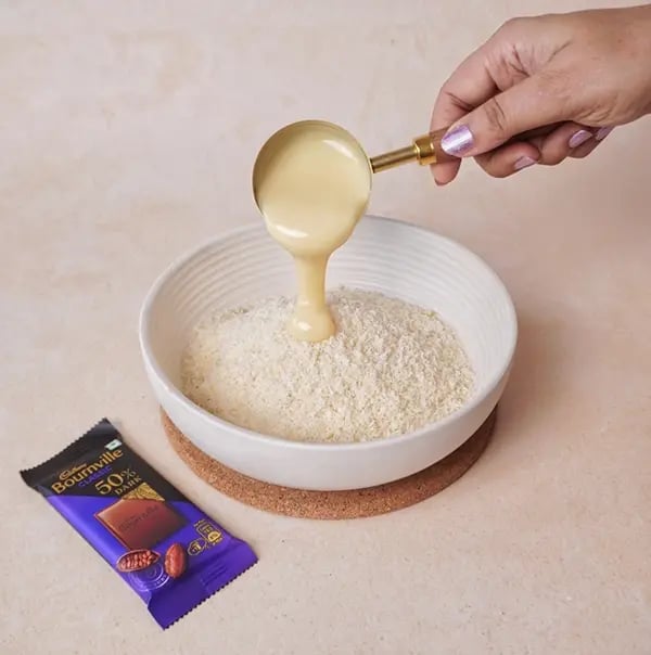 Bournville Chocolate and Coconut Candy Bar-In a large bowl combine shredded coconut