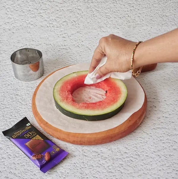 Bournville Chocolate and Watermelon Lollipops-Place the watermelon slice on parchment paper