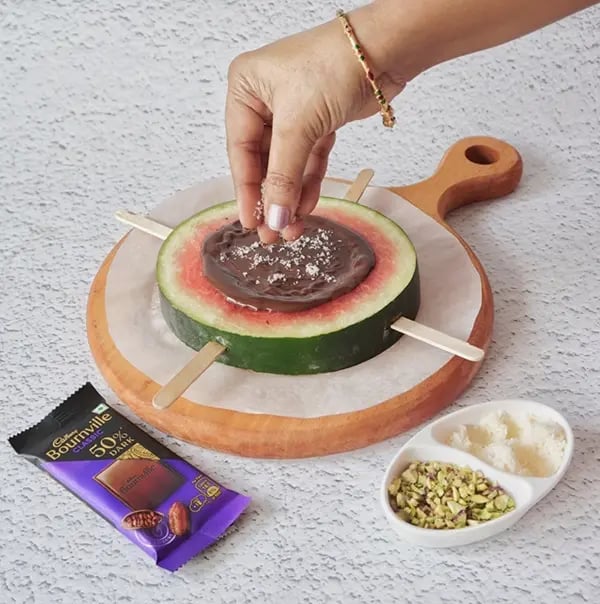Bournville Chocolate and Watermelon Lollipops-Sprinkle some desiccated coconut over the melted chocolate