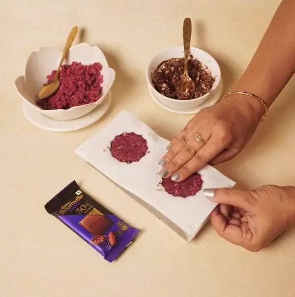 Bournville Chocolate Coated Red Velvet Giant Modak with Coconut and Nuts for Ganesh Chaturthi - Adding more of the coconut mixture on top