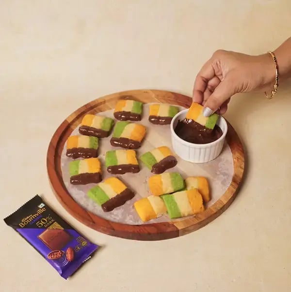 Bournville Chocolate Coated Tricolor Delight Cookies - INDEPENDENCE DAY - Dip one side of each square cookie into the melted chocolate
