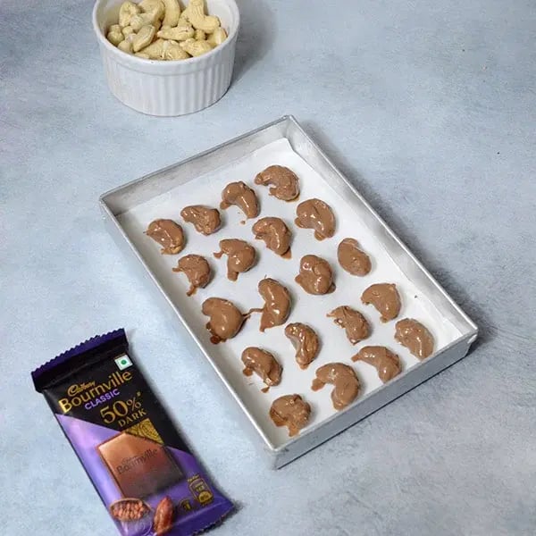 Bournville Chocolate Covered Cashews - Place chocolate coated cashew on the baking sheet