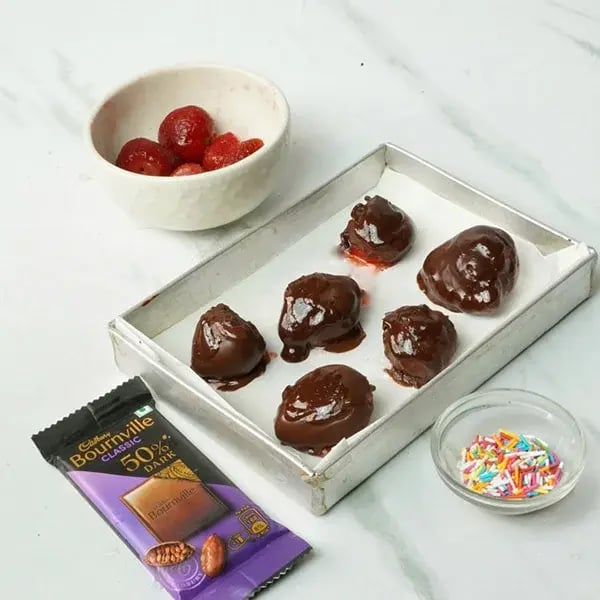 Bournville Chocolate Dipped Strawberries - Strawberries on a parchment-lined tray