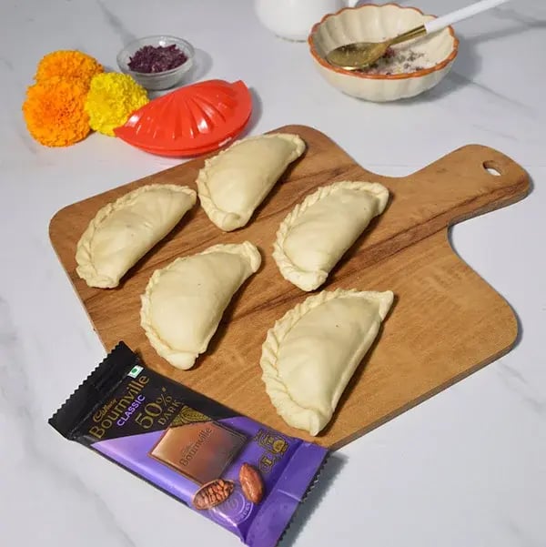 Bournville Chocolate Dipped Tutti Frutti Gujiya - Fold in the excess dough