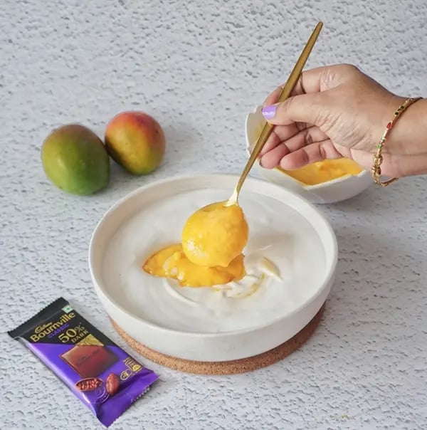 Bournville Chocolate Drizzled Mango Ice Cream-Carefully fold the mango mixture