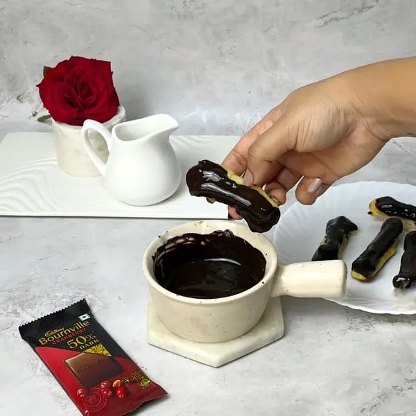 Bournville Chocolate Eclairs - Dipping Eclair In Glaze