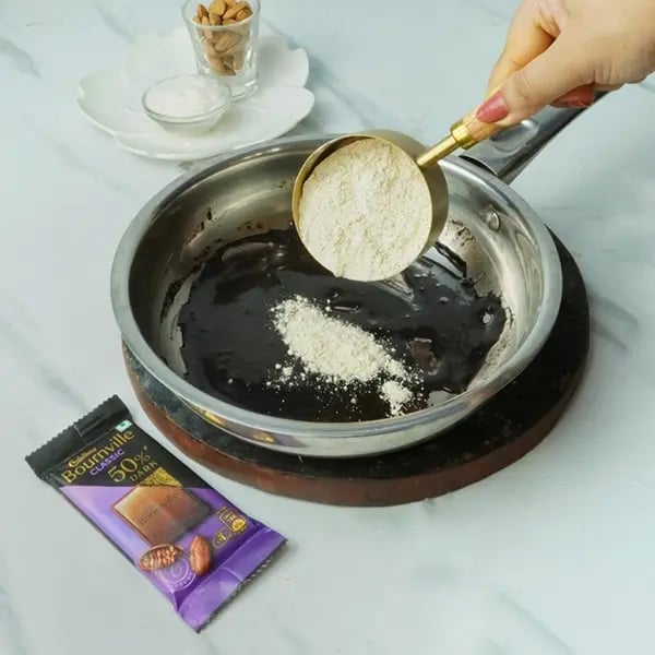 Bournville Chocolate Laddo With Coconut Almond-Now add besan into the same pan