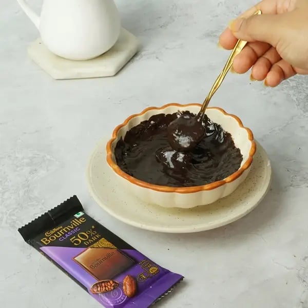 Bournville Covered No-Bake Biscoff Cheesecake-Melt the chocolate using a double boiler