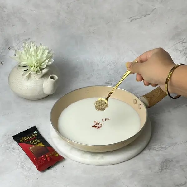 Bournville Drizzled Tasmai Kheer - Adding Cinnamon Powder