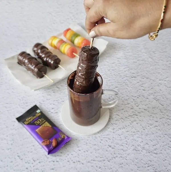 Bournville Fruit Pops - Dip the fruit pops into the melted chocolate