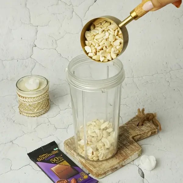Bournville Kesar Kaju Katli - Add cashews to a grinder