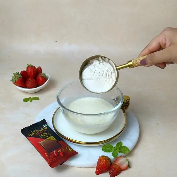 Bournville Mini Chocolate Strawberry Bundt Cake - Adding Flour To Bowl