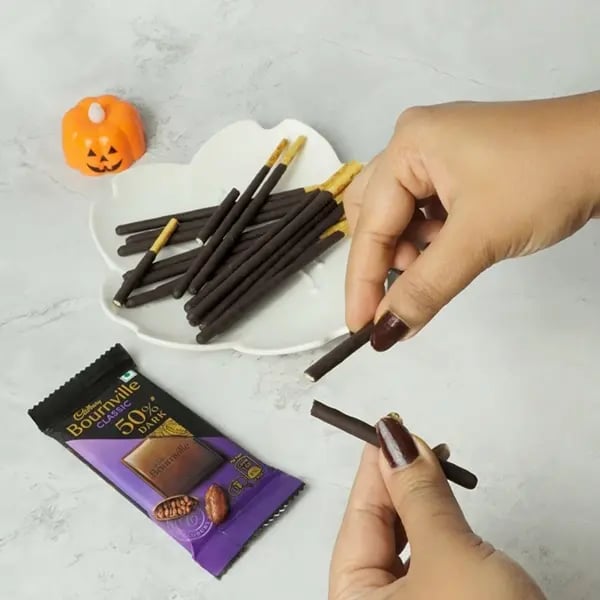 Bournville Pocky Web Spider Bites for Halloween-Gently break pocky sticks