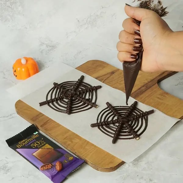 Bournville Pocky Web Spider Bites for Halloween-Starting in the centre of each spider