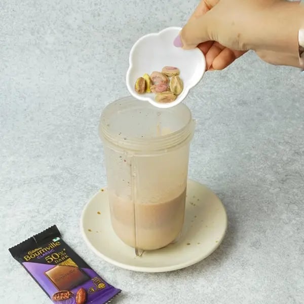 Bournville Soan Papdi Pistachio Milkshake-Add soaked pistachios into the blended mixture