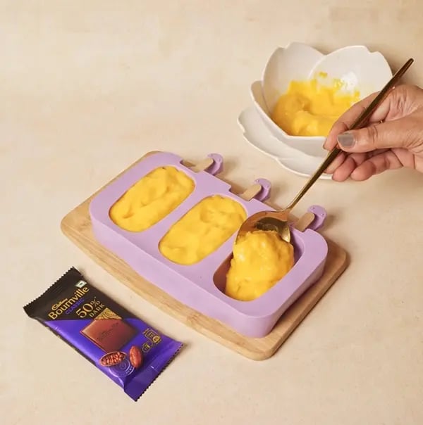 Cadbury Bournville Mango Pops-Carefully pour the mango-yogurt mixture