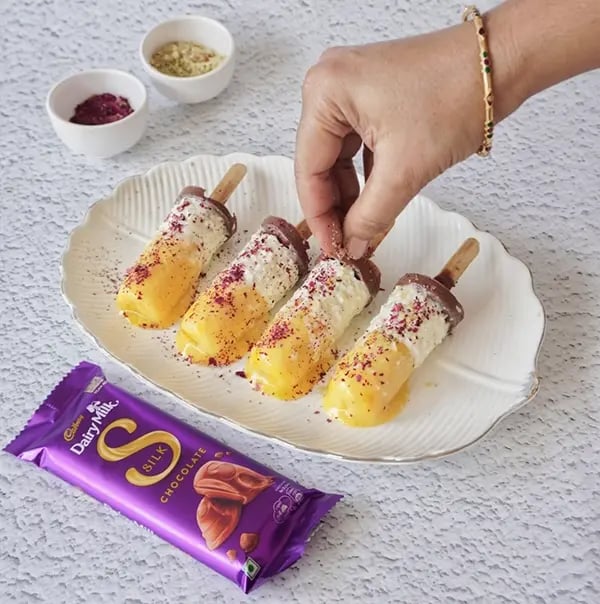Cadbury Dairy Milk Silk and Mango Layered Kulfi with Cashew Nuts - Demold and garnish with dry rose petals