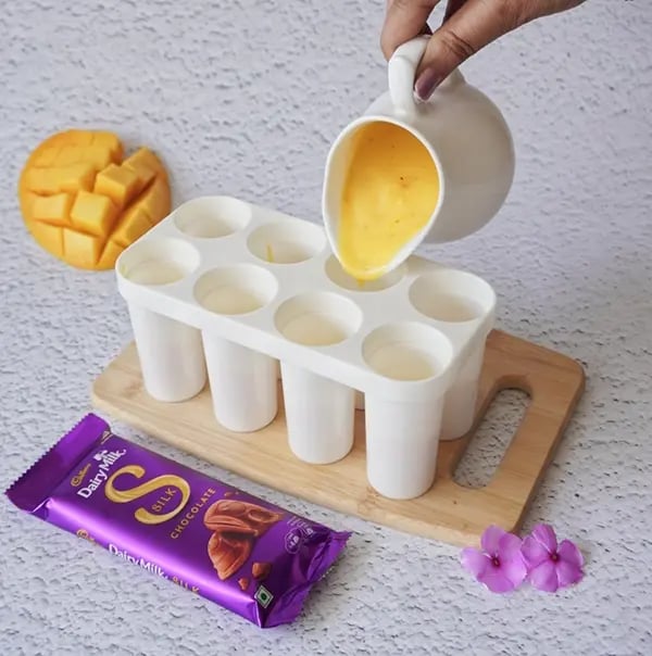 Cadbury Dairy Milk Silk and Mango Layered Kulfi with Cashew Nuts - Pour a layer of mango mixture