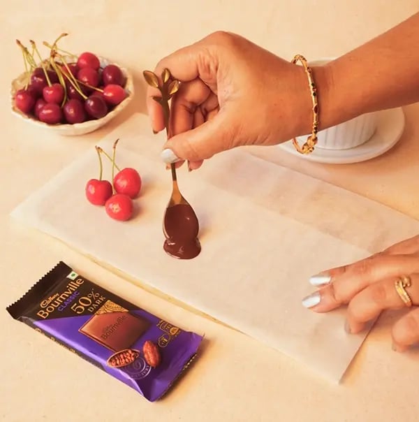 Cherry Notes On A Plate With Cadbury Bournville-On a sheet of parchment paper