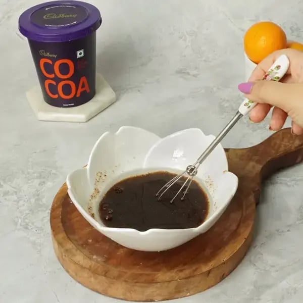 Choco Orange Cake With Hazelnut Garnish - Combine the vegetable oil and jaggery
