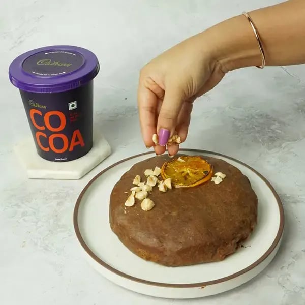 Choco Orange Cake With Hazelnut Garnish - Garnish the cupcakes with chopped hazelnuts and fresh orange slices