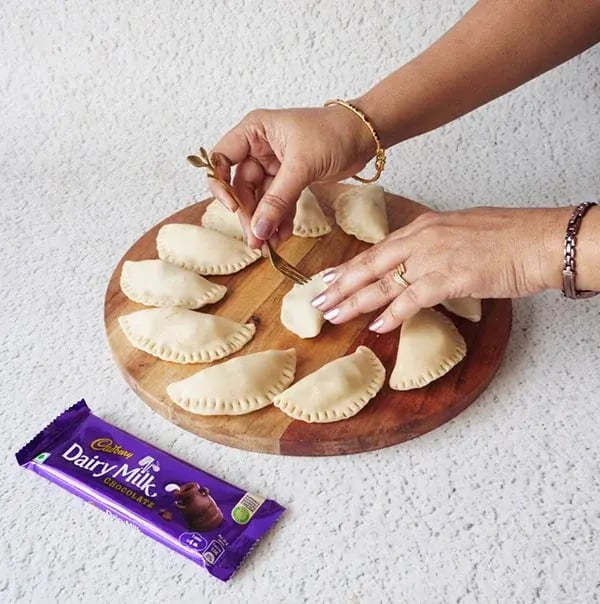 Chocolate Baked Gujiya With Dry Fruits &amp; Coconut - Fold the dough in half