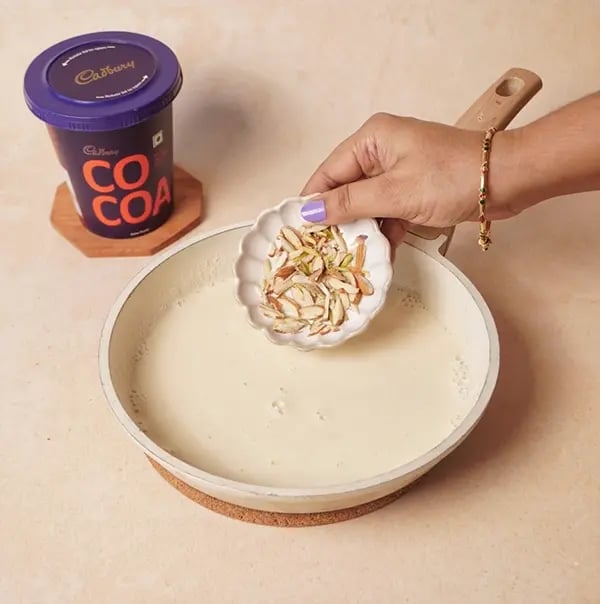 Chocolate Basundi with Mango-Stir in the chopped nuts