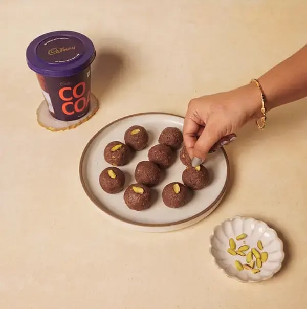 Chocolate Coconut Laddu with Pistachio for JANMASTHAMI - Garnish each laddu with thin slices of pistachio